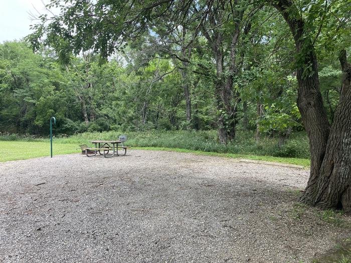 A photo of Site 310 of Loop OAK CAMPGROUND at BLOOMINGTON EAST  with Picnic Table, Fire Pit, Shade, Lantern Pole