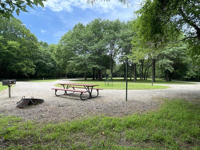 A photo of Site 319 of Loop OAK CAMPGROUND at BLOOMINGTON EAST  with Picnic Table, Fire Pit, Shade, Lantern Pole