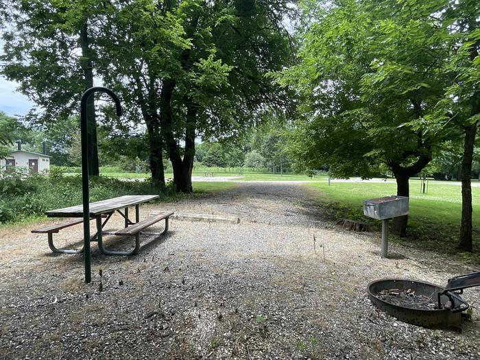 A photo of Site 307 of Loop OAK CAMPGROUND at BLOOMINGTON EAST  with Picnic Table, Fire Pit, Shade, Lantern Pole