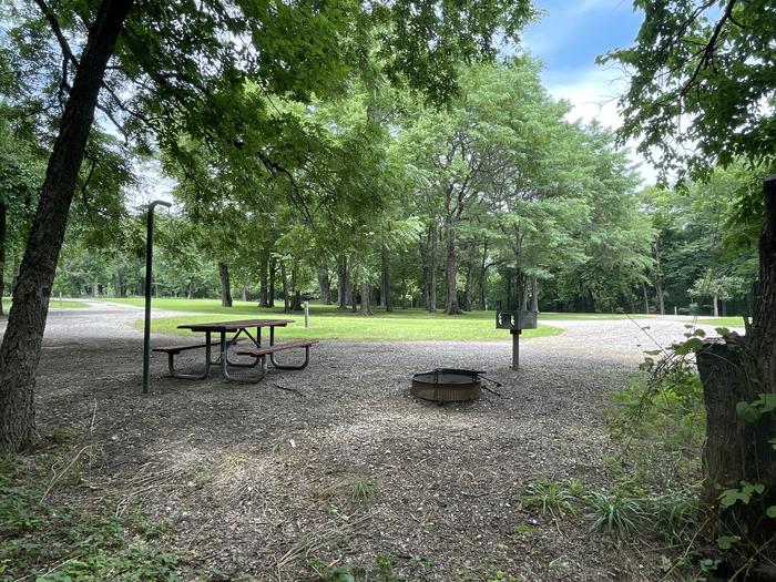 A photo of Site 318 of Loop OAK CAMPGROUND at BLOOMINGTON EAST  with Picnic Table, Fire Pit, Shade, Lantern Pole