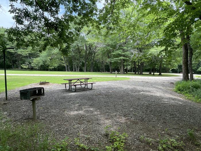 A photo of Site 317 of Loop OAK CAMPGROUND at BLOOMINGTON EAST  with Picnic Table, Fire Pit, Shade, Lantern Pole