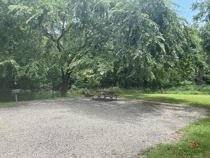 A photo of Site 309 of Loop OAK CAMPGROUND at BLOOMINGTON EAST  with Picnic Table, Fire Pit, Shade, Lantern Pole