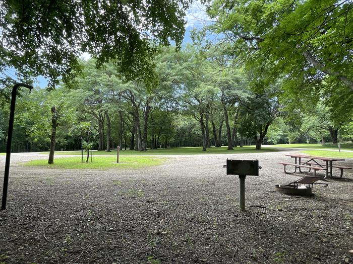 A photo of Site 320 of Loop OAK CAMPGROUND at BLOOMINGTON EAST  with Picnic Table, Fire Pit, Shade, Lantern Pole