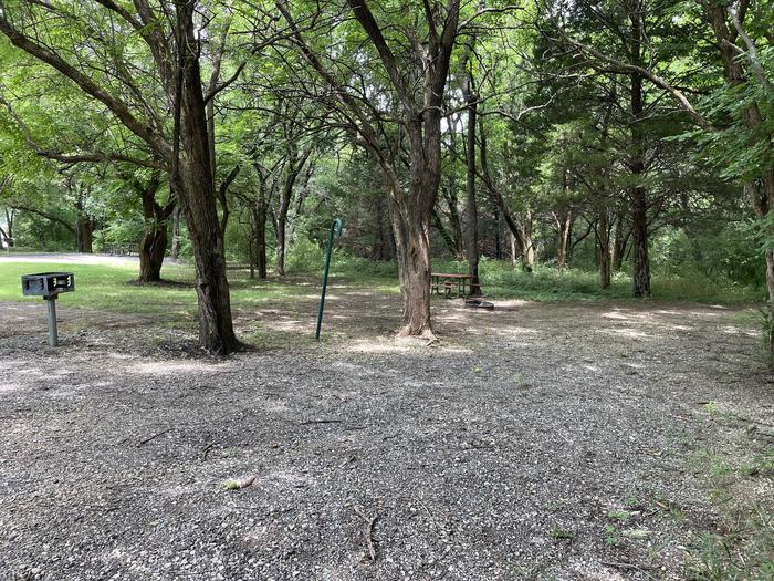 A photo of Site 303 of Loop OAK CAMPGROUND at BLOOMINGTON EAST  with Picnic Table, Fire Pit, Shade, Lantern Pole