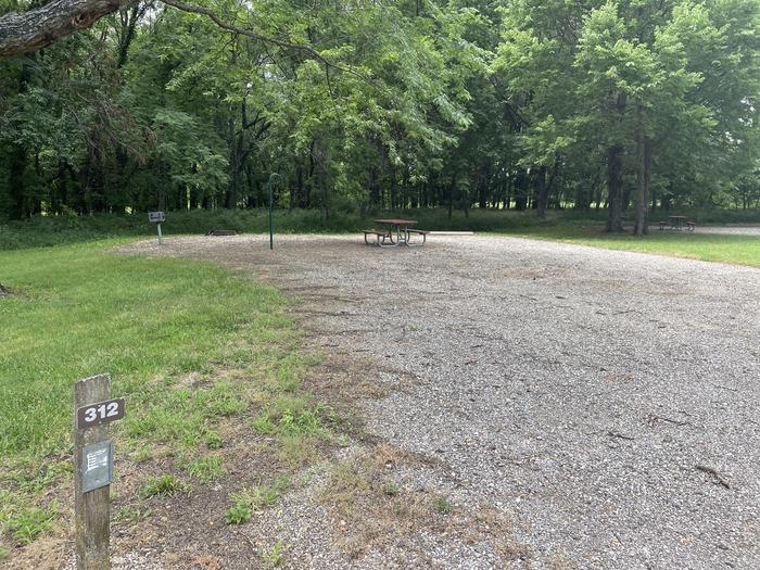 A photo of Site 312 of Loop OAK CAMPGROUND at BLOOMINGTON EAST  with Picnic Table, Fire Pit, Shade, Lantern Pole