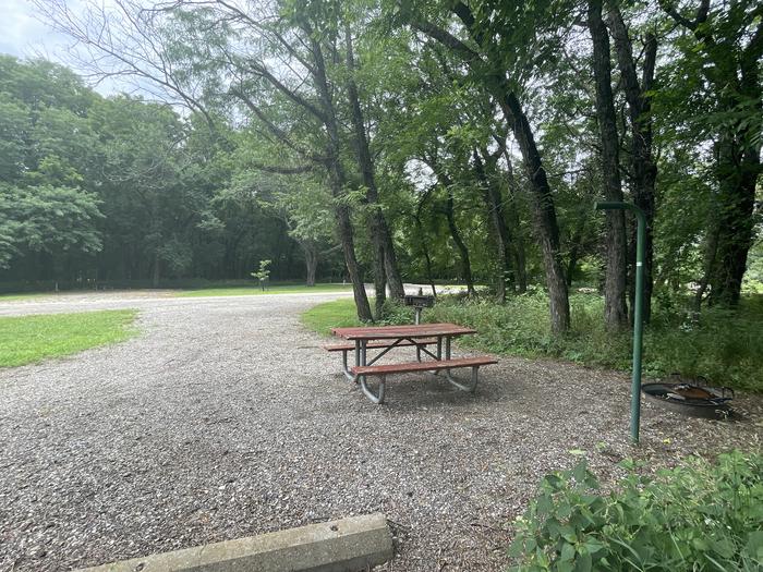 A photo of Site 313 of Loop OAK CAMPGROUND at BLOOMINGTON EAST  with Picnic Table, Fire Pit, Shade, Lantern Pole