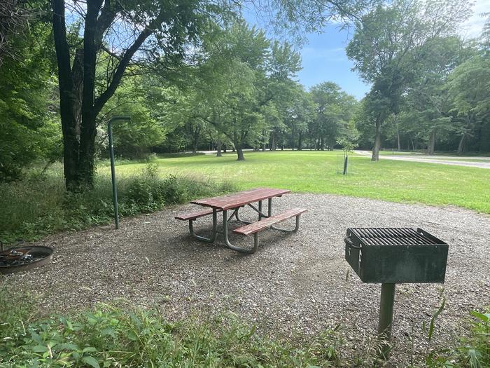 A photo of Site 313 of Loop OAK CAMPGROUND at BLOOMINGTON EAST  with Picnic Table, Fire Pit, Shade, Lantern Pole
