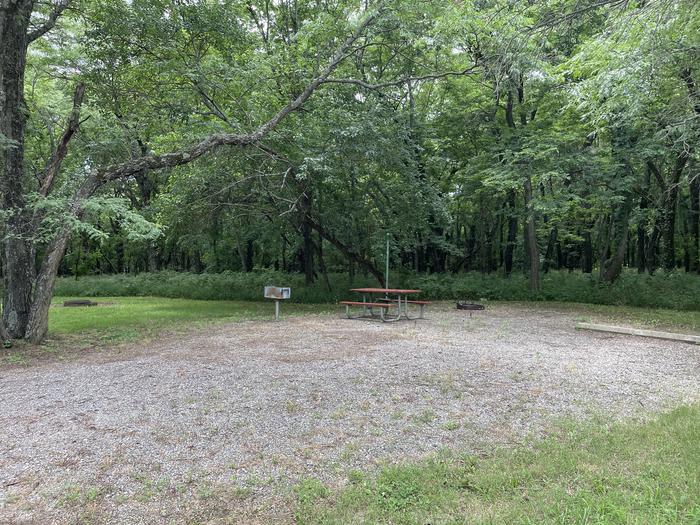 A photo of Site 315 of Loop OAK CAMPGROUND at BLOOMINGTON EAST  with Picnic Table, Fire Pit, Shade, Lantern Pole