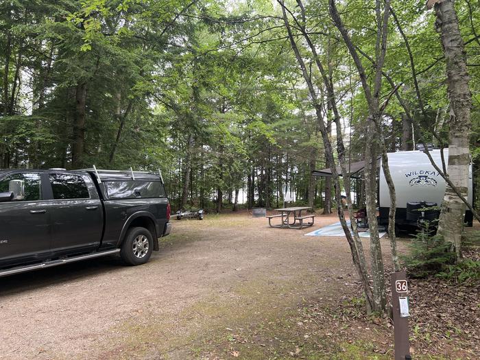 A photo of Site X36 of Loop MANAGEMENT SITES at BREVOORT LAKE CAMPGROUND with Picnic Table, Fire Pit, Shade, Waterfront, Lantern Pole