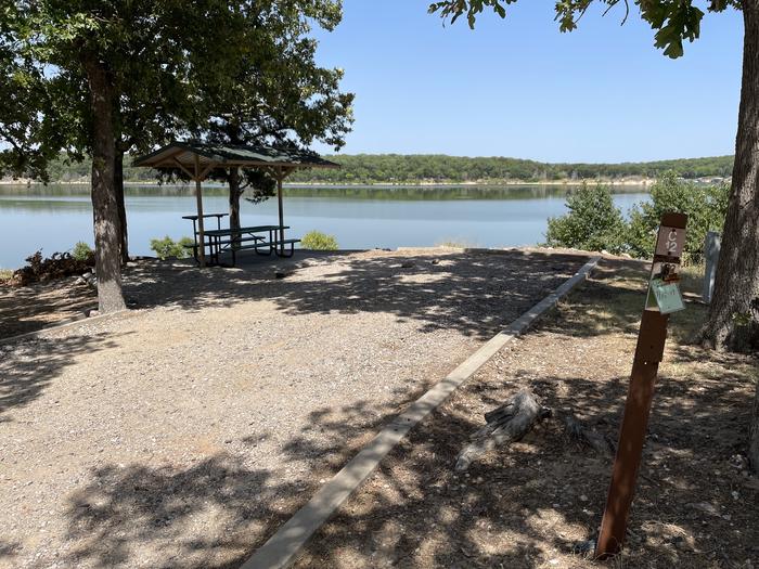 A photo of Site C12 of Loop C at BUNCOMBE CREEK with Picnic Table, Electricity Hookup, Fire Pit, Shade, Waterfront, Water Hookup