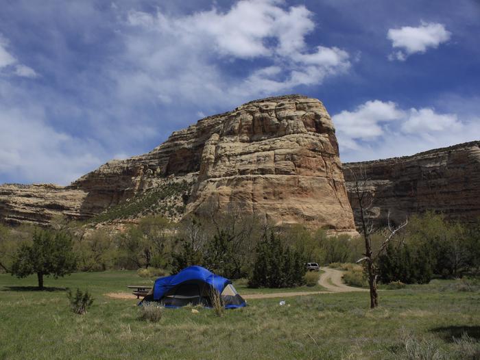 Echo Park Campground with Steamboat Rock in background.Blue tent setup in Echo Park Campground with Steamboat Rock in background.