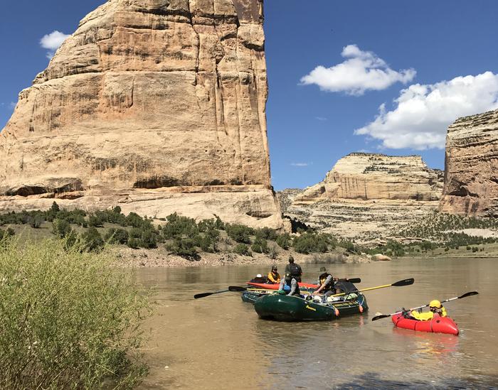 Two rafts and an inflatable kayak in river at base of Steamboat Rock near Echo Park Group SiteRiver front near Echo Park Group Site