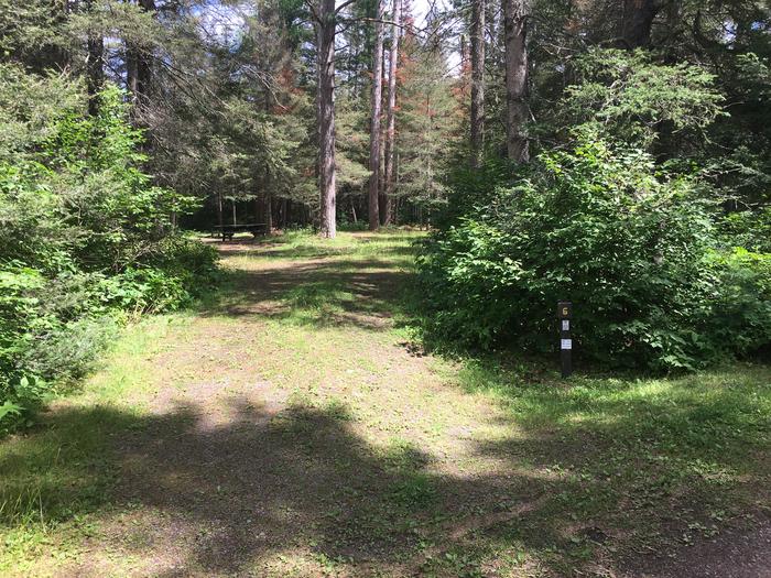 A photo of Site 6 of Loop West Loop at Little Isabella River Campground with No Amenities Shown. Driveway pictured.Parking area