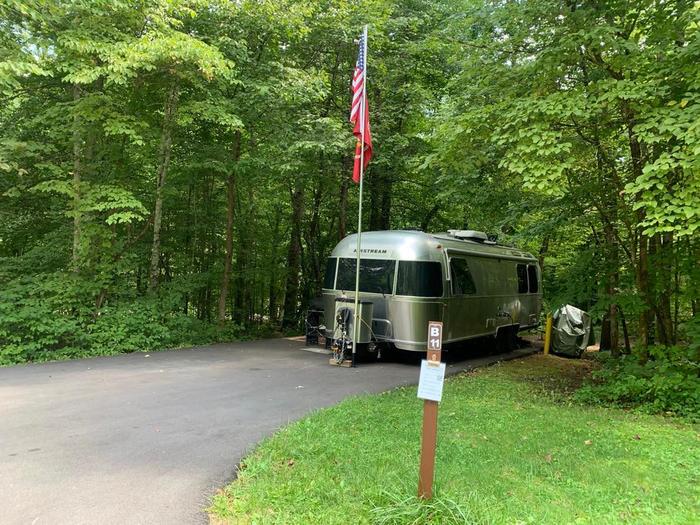 A blacktop area with a silver trailer.