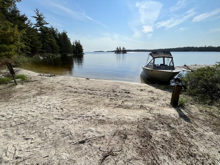R59 - Finlander Island, view looking out from sand boat access with a boat tied to the mooring post.View looking out from boat access