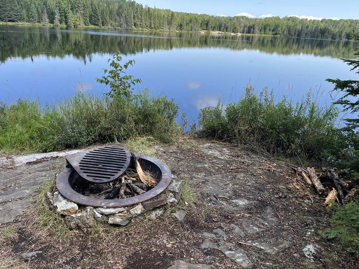 B7 - Jorgens Lake, view of campfire ring overlooking the water.View looking out from campsite.
