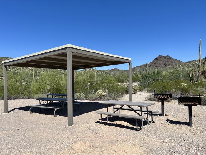 A group site with a shade ramadaA photo of a group site at TWIN PEAKS CAMPGROUND with a shade Ramada, picnic table, a grill