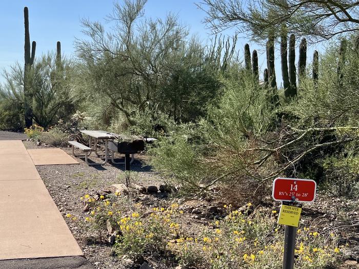 The driveway entrance into the campsite with a sign in front.