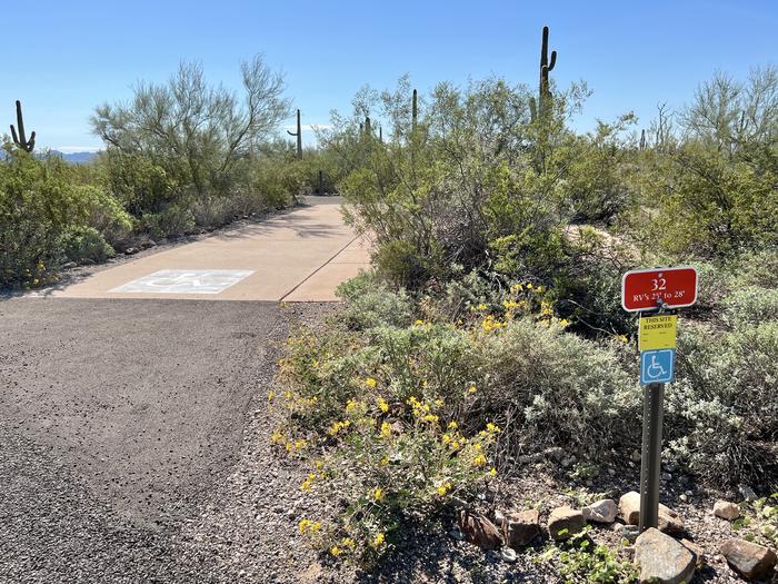 The driveway entrance into the campsite with a sign in front.