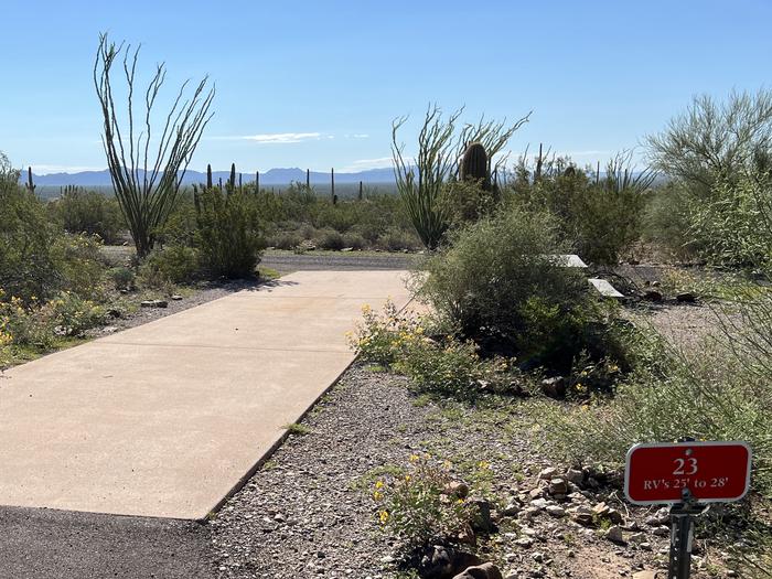 The driveway entrance into the campsite with a sign in front