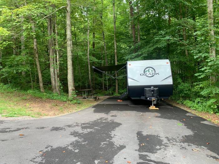 A blacktop pad with a white camper.