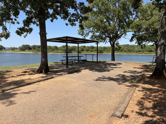 A photo of Site 15 of Loop JCRE at JOHNSON CREEK with Picnic Table, Electricity Hookup, Fire Pit, Shade, Waterfront, Water Hookup