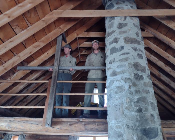 Crews installing railing in cabin loft