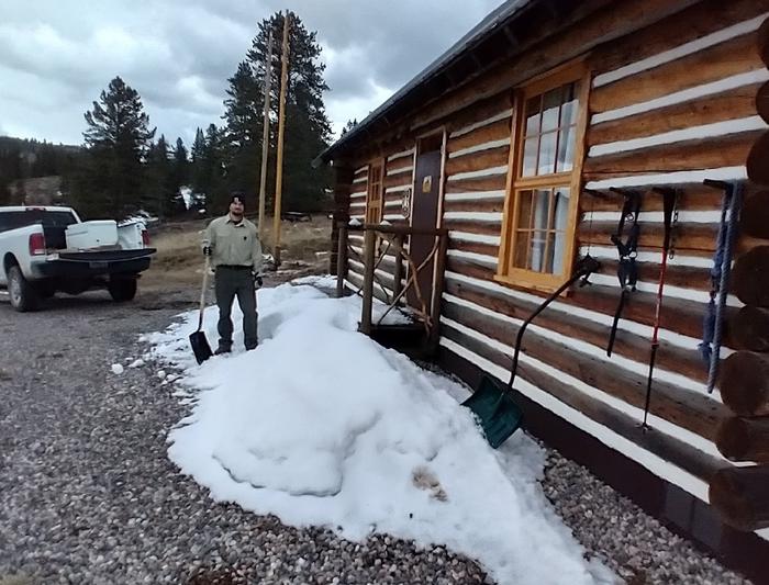 Clearing snow from cabin front door