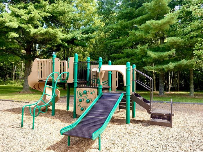 Black slide and tan and green playground equipmentPlayground next to Redbud Picnic Shelter