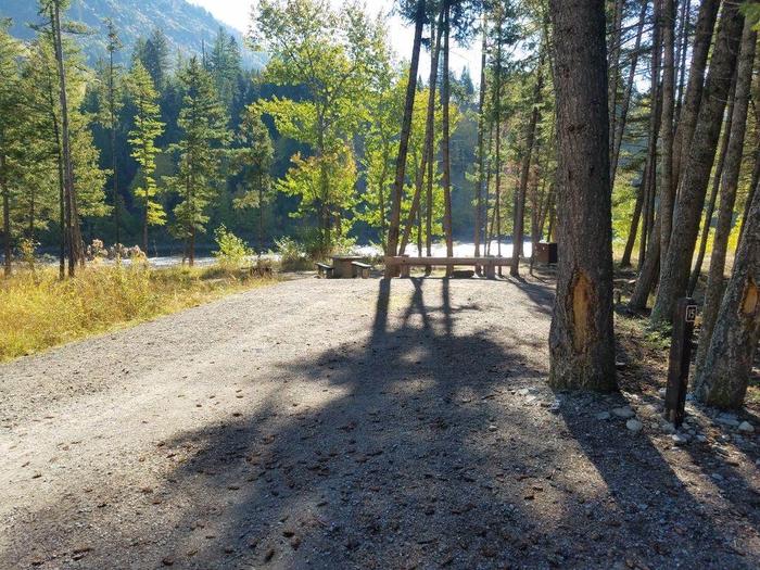 A photo of Site 15 of Loop BIG CREEK CAMPGROUND at Big Creek Campground (Flathead National Forest, MT) with Picnic Table, Fire Pit, Food Storage shared with sute 14, Waterfront