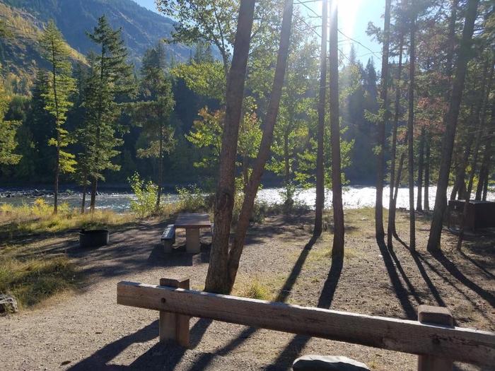A photo of Site 15 of Loop BIG CREEK CAMPGROUND at Big Creek Campground (Flathead National Forest, MT) with Picnic Table, Fire Pit, Food Storage shared with site 14, Waterfront