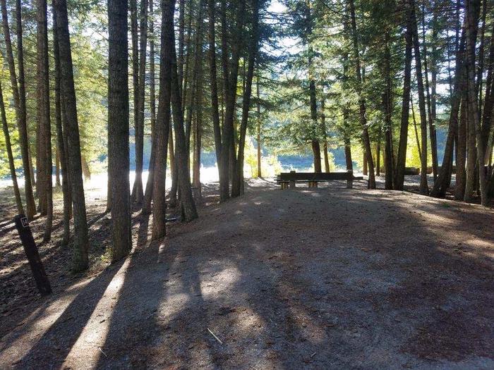 A photo of Site 14 of Loop BIG CREEK CAMPGROUND at Big Creek Campground (Flathead National Forest, MT) with Picnic Table, Fire Pit, Shade, Food Storage shared with site 15, Waterfront