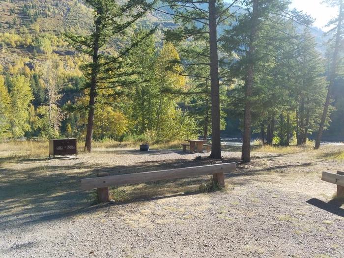 A photo of Site 16 of Loop BIG CREEK CAMPGROUND at Big Creek Campground (Flathead National Forest, MT) with Picnic Table, Fire Pit, Food Storage, Waterfront