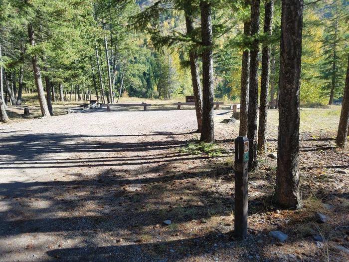 A photo of Site 16 of Loop BIG CREEK CAMPGROUND at Big Creek Campground (Flathead National Forest, MT) with Picnic Table, Fire Pit, Food Storage and driveway shared with site 17, Waterfront