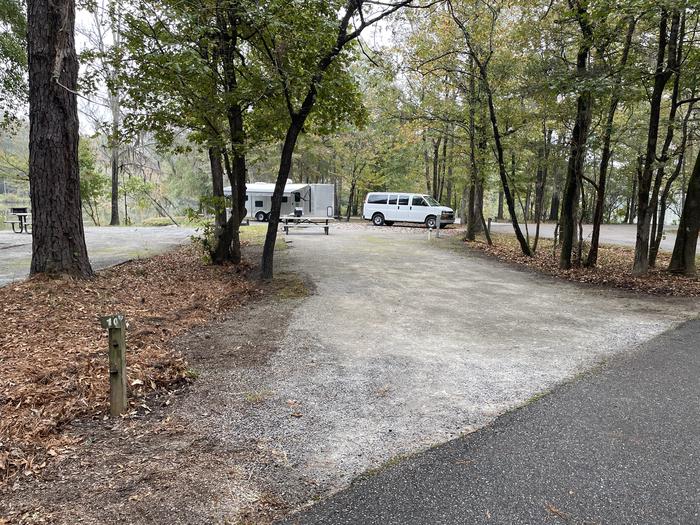 A photo of Site 010 of Loop PRAIRIE CREEK (AL) at PRAIRIE CREEK (AL) with Picnic Table, Electricity Hookup, Fire Pit, Shade, Waterfront, Lantern Pole, Water Hookup