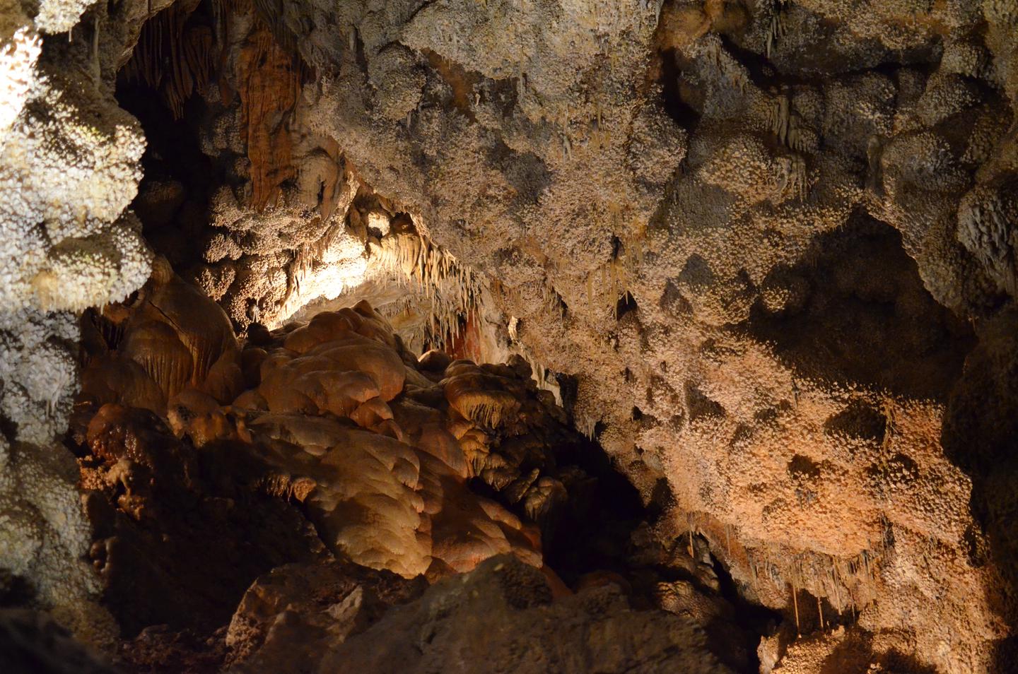 A large room inside a cave with stalactites, calcite, and flowstone.Visit the Formation Room and learn about Jewel Cave on our Scenic Tour. 