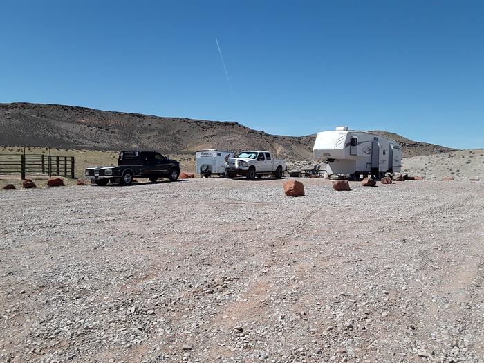Courthouse Rock Campground campsite 6 with trailers, vehicles, and horse corrals