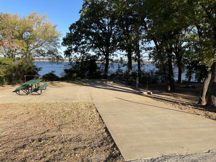 A photo of Site D02 of Loop D at JUNIPER POINT with Picnic Table, Electricity Hookup, Fire Pit, Shade, Waterfront, Water Hookup
