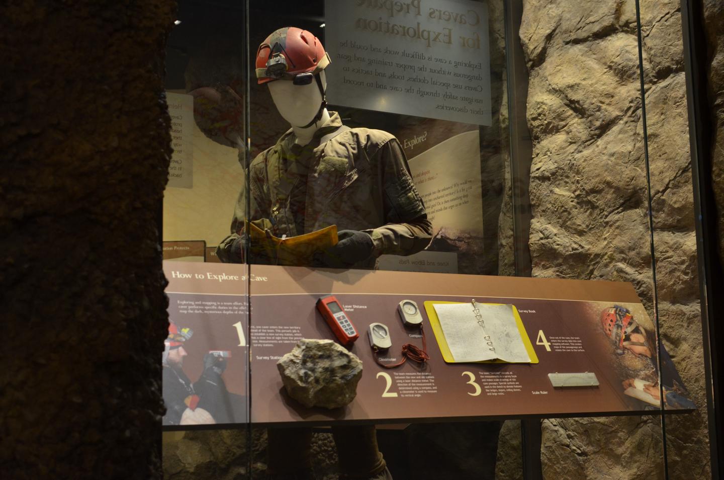 A mannequin dressed in caving gear is posed in a display that explains the itemsLearn about what it takes to be a cave explorer!