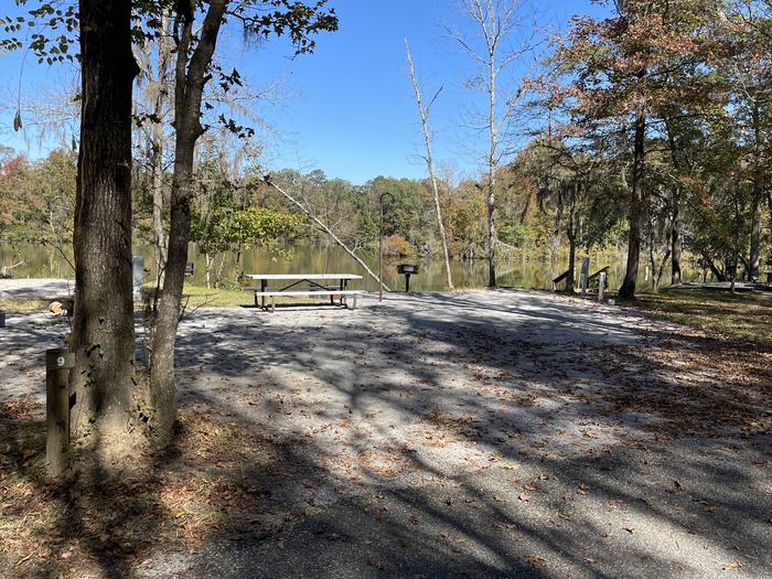 A photo of Site 009 of Loop PRAIRIE CREEK (AL) at PRAIRIE CREEK (AL) with Picnic Table, Electricity Hookup, Fire Pit, Shade, Waterfront, Lantern Pole, Water Hookup, Curtesy Dock 