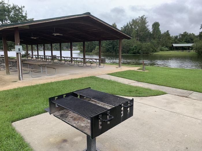 White Oak Creek Day Use Picnic Shelter #1 with grill in foreground and water spigot in background