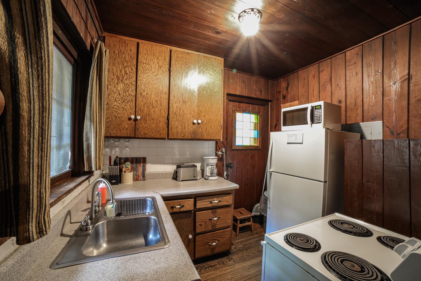 White Rock Mountain, Cabin A KitchenCabin A kitchen features new appliances, including an electric stove, refrigerator, microwave, toaster, coffee pot, crock pot, cooking utensils, pots & pans, vintage dishes, and much more!