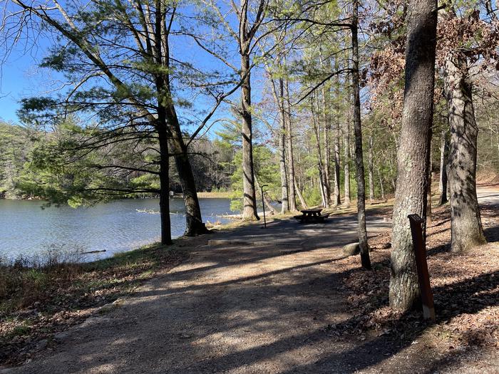 A photo of Site 19 of Loop Lower at Lake Conasauga Campground with Picnic Table, Fire Pit, Shade, Tent Pad, Waterfront, Lantern Pole from entrance.A photo of Site 19 of Loop Lower at Lake Conasauga Campground with Picnic Table, Fire Pit, Shade, Tent Pad, Waterfront, Lantern Pole