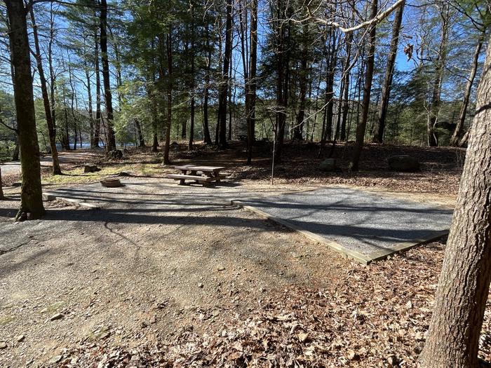 A photo of Site 23 of Loop Lower at Lake Conasauga Campground with Picnic Table, Fire Pit, Shade, Tent Pad, Lantern Pole from beside.A photo of Site 23 of Loop Lower at Lake Conasauga Campground with Picnic Table, Fire Pit, Shade, Tent Pad, Lantern Pole