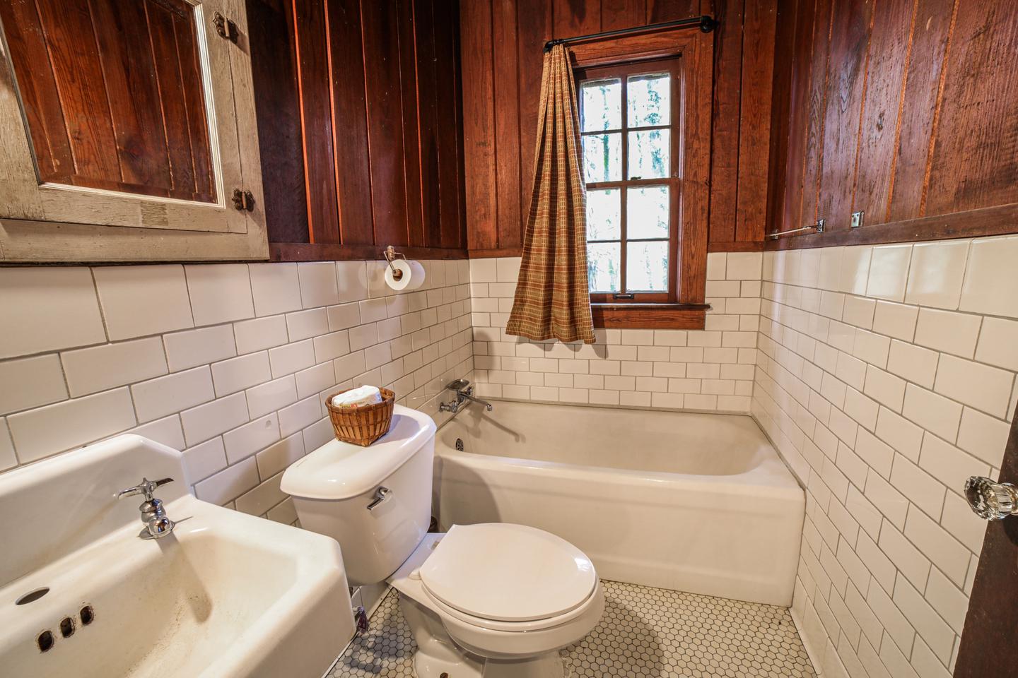 White Rock Mountain, Cabin B BathroomCabin B bathroom features a deep cast iron tub, vintage sink, and flush toilet.