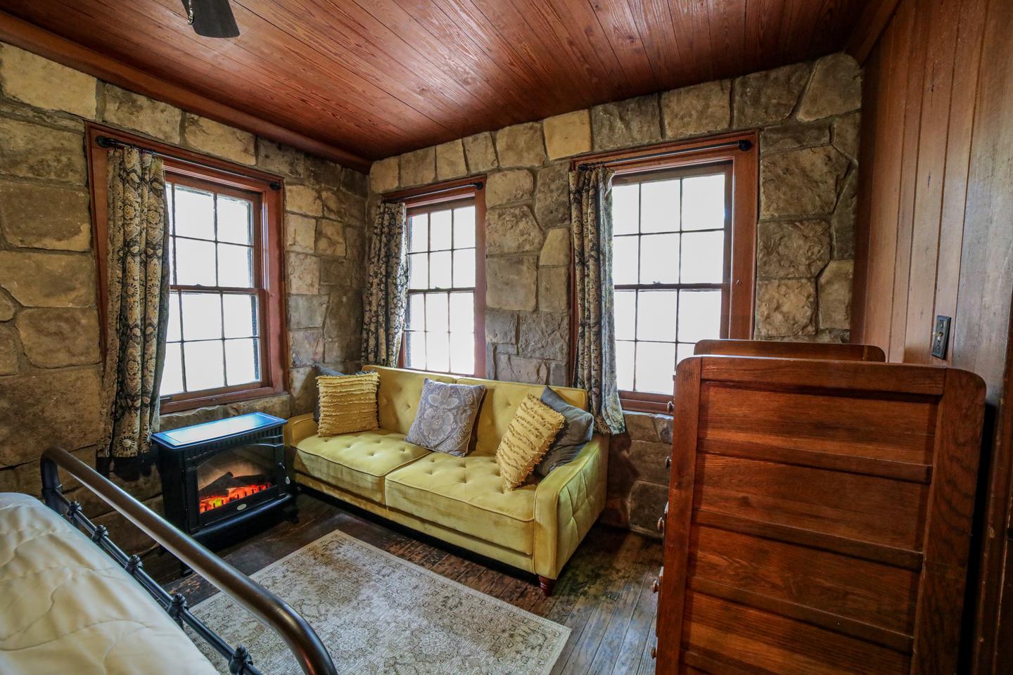 White Rock Mountain, Cabin C Bedroom with sofa and seasonal fireplace.Cabin C's Bedroom with sofa and seasonal fireplace.
