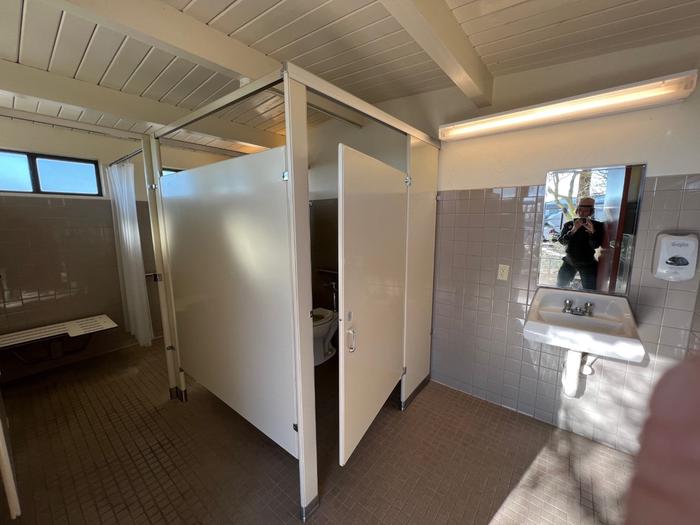 The interior of the campground bathrooms, featuring an ADA stall and shower.The restrooms are ADA accessible, and restrooms 1, 4, and 5 feature free solar-heated showers.
