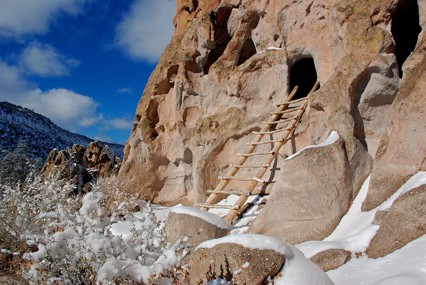Wooden ladder leading up to a caveThe Pueblo Loop Trail is home to the excavated archaeological sites within Bandelier National Monument. Park visitors are able to climb ladders and explore some of the archaeological sites.
