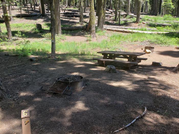 Spacious site with a mix of sun and shade that features a picnic tabe and fire ring.Grizzly Creek Site 6