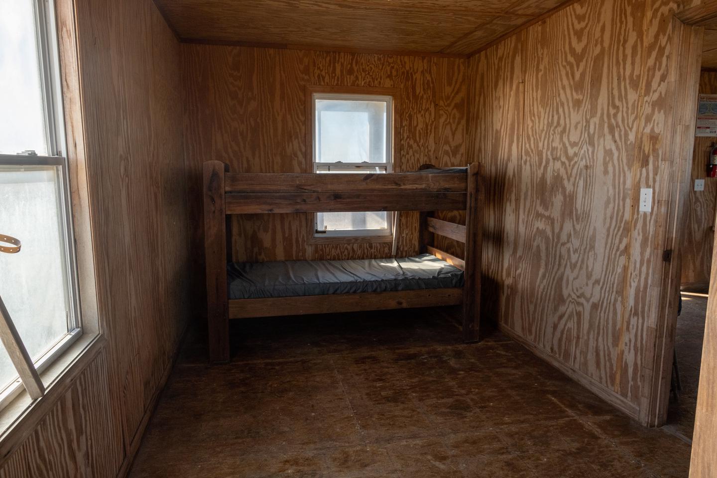 Another view of the bedroom with an additional bunk bed against the wall.Bedroom area.